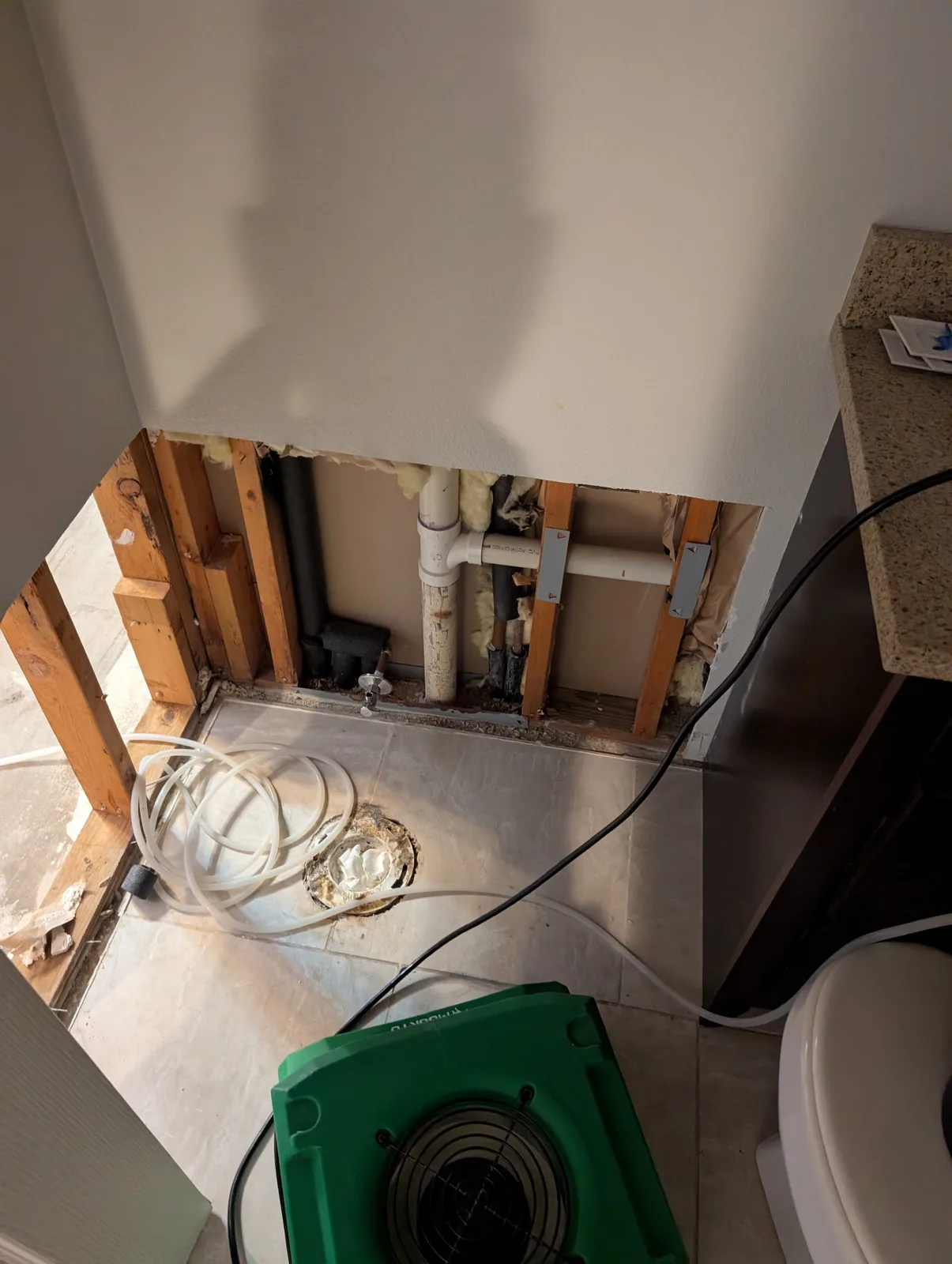 Moisture source exposed and drying underway during mold remediation in a Frisco, TX bathroom