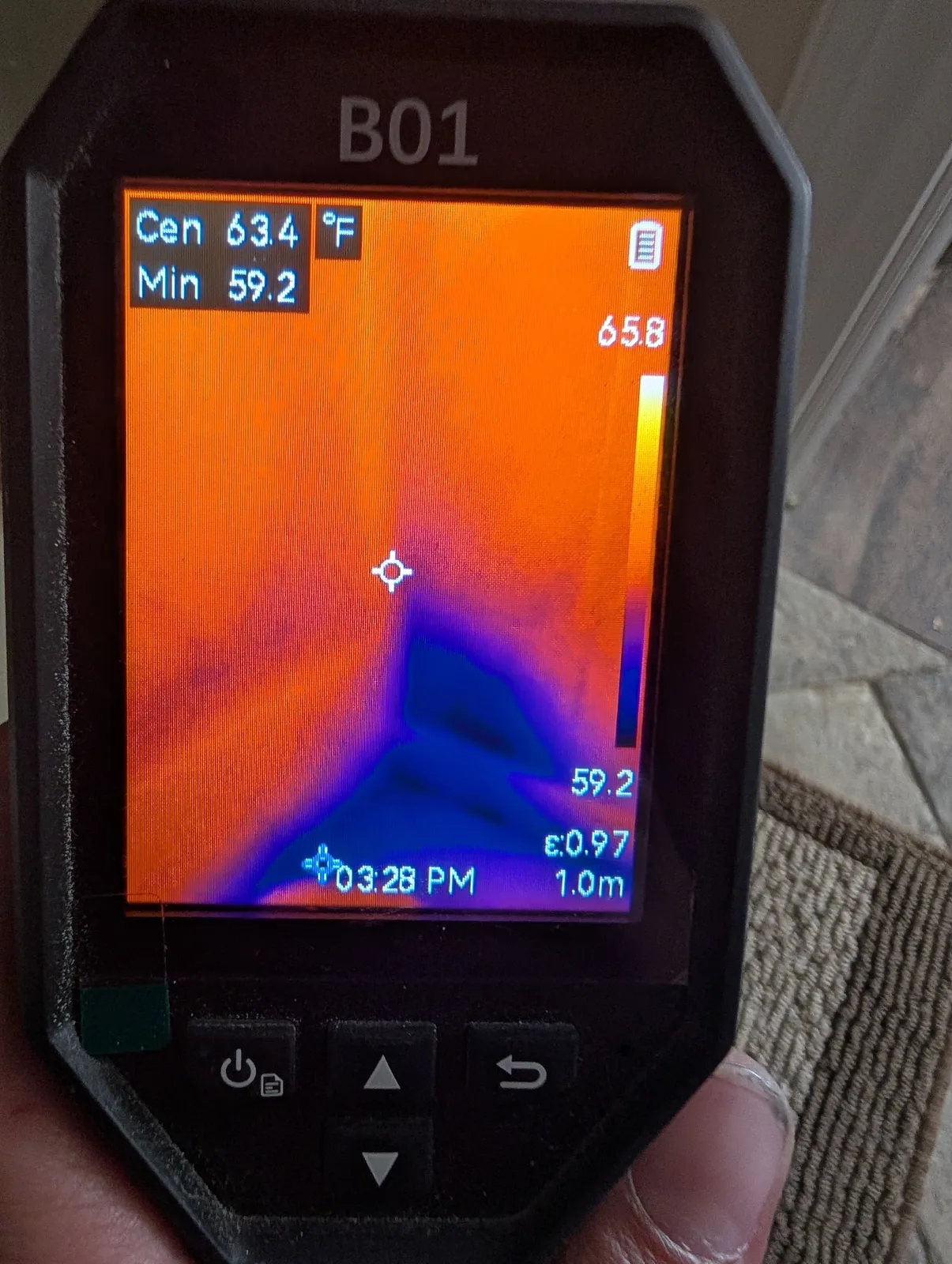 Thermal imaging camera revealing hidden moisture at a wall base during a North Texas water mitigation job
